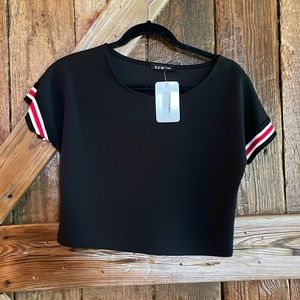 Black cropped tee with red and white stripes on sleeves